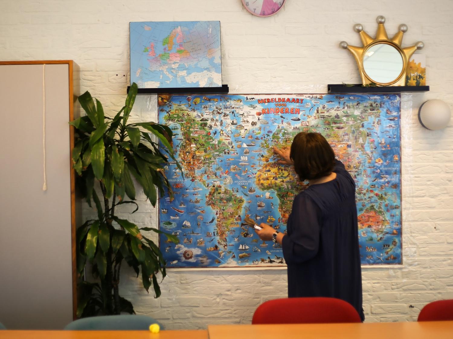 Zeynep with a world map.